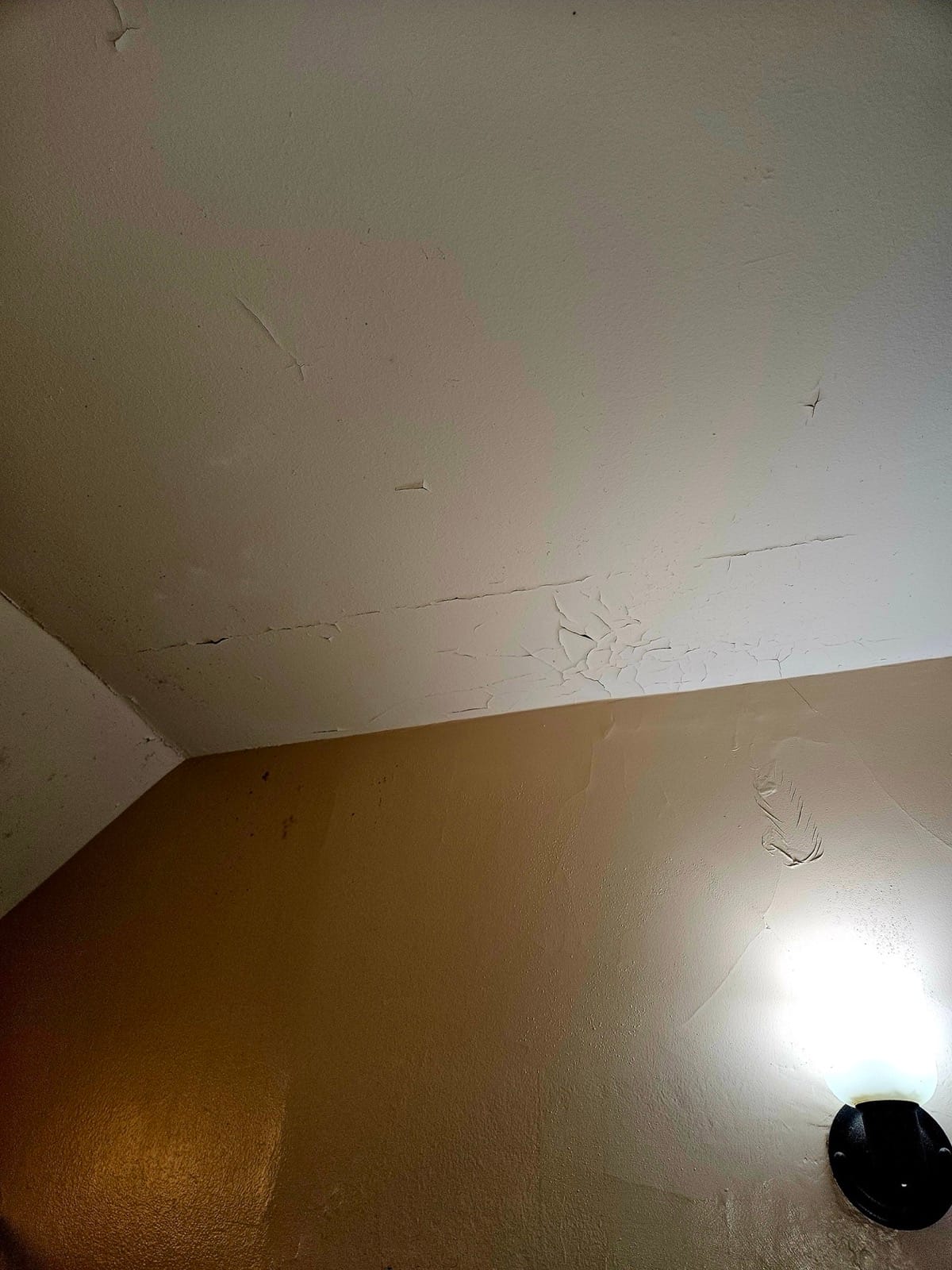 Ceiling water stain from ice dam damage in a NH home